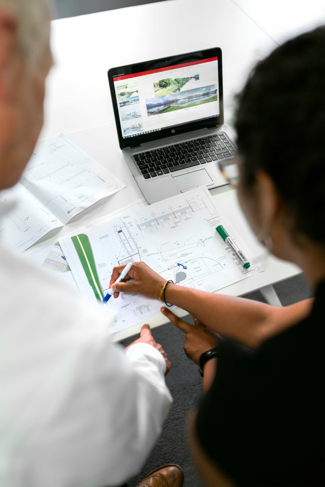 about-02 Female civil engineer discusses flood risk management plans with colleague